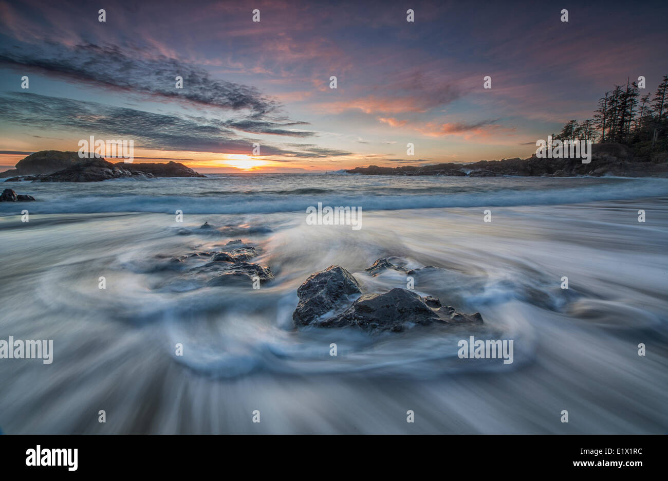 L'eau s'écoule autour des roches South Beach comme la marée haute sunset approches le parc national Pacific Rim en Colombie-Britannique, Canada. Banque D'Images