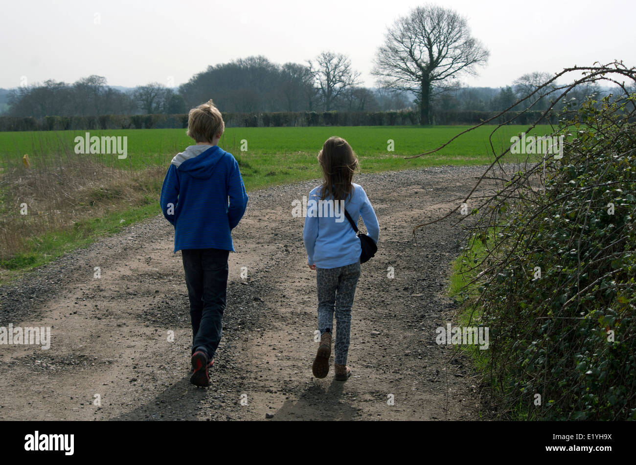 Les enfants de la marche à l'extérieur au printemps. La fratrie -11 ans garçon et fille de 9 ans. Banque D'Images