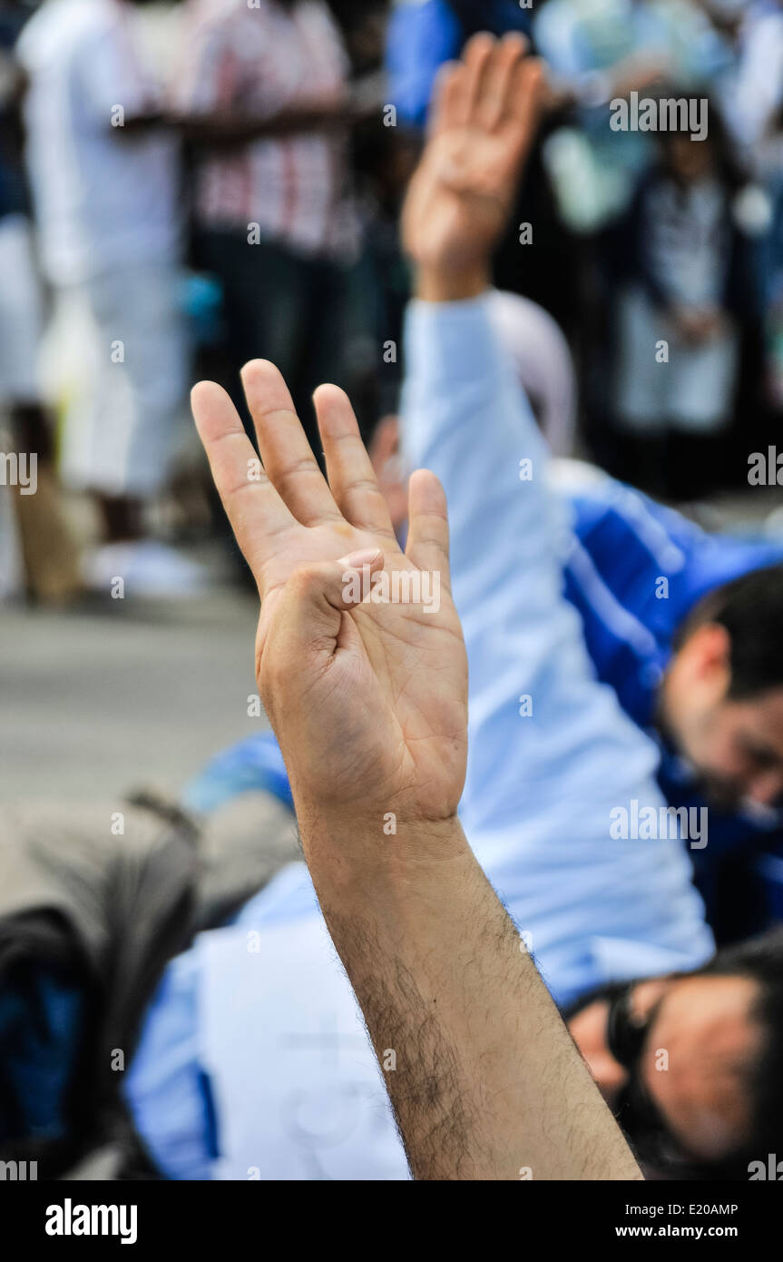 Les Egyptiens donnent une quatre frères musulmans fingered salute comme ils l'étape de protester contre les violations des droits de l'homme en Egypte y compris la mort, l'emprisonnement et la violence soutenue par l'état Banque D'Images