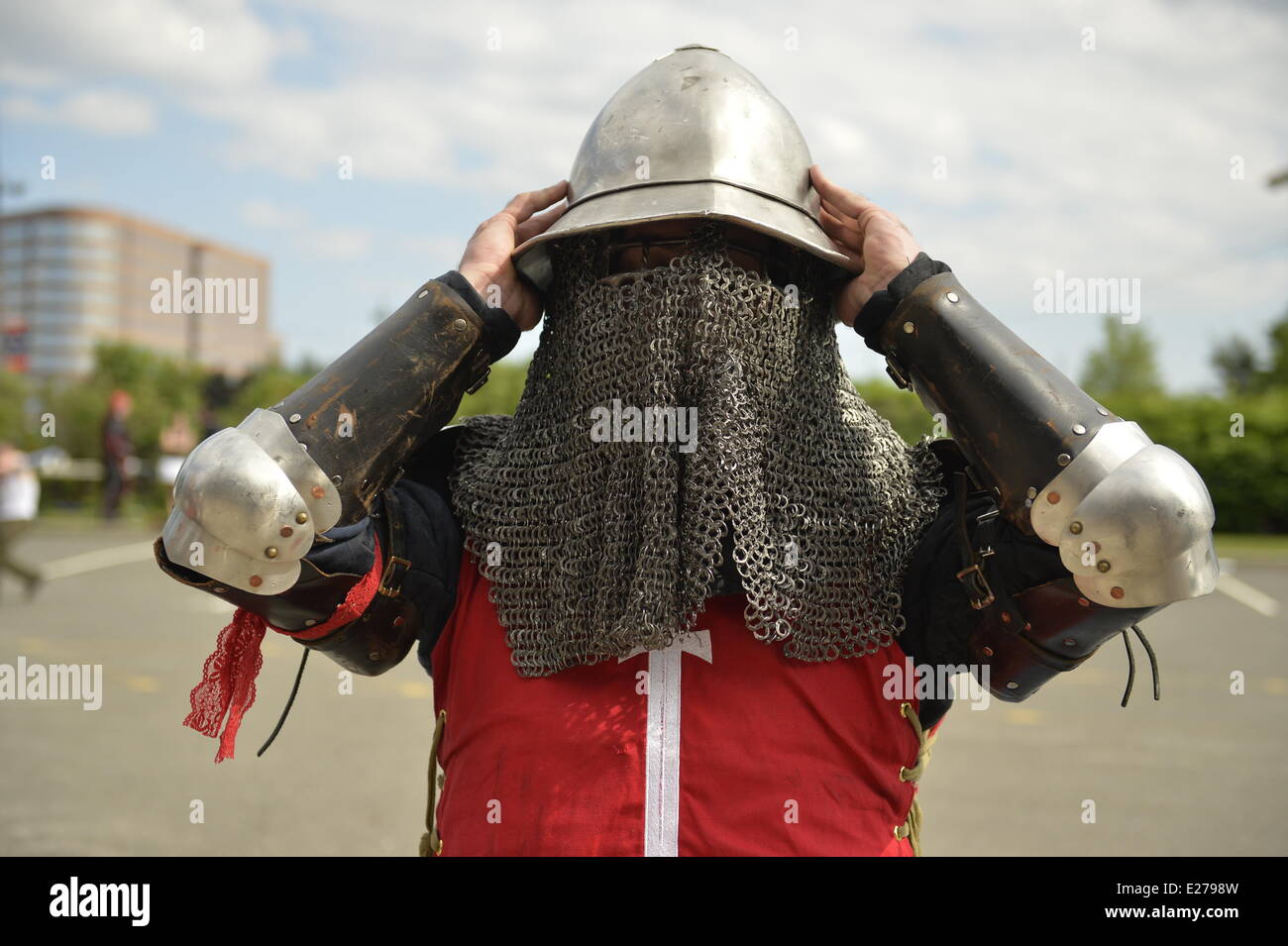 Garden City, New York, États-Unis - 14 juin 2014 - SAM DE TRAVERS est un membre des Chevaliers USA mise sur son casque avec maille protection, portant des armures de combat guerrier éternel au Con, la Pop Culture Expo annuelle, tenue au berceau de l'Aviation Museum sur Long Island. Véhicules blindés de combat des membres de la Ligue à la concurrence sur les compétitions de combat médiéval. Credit : Ann E Parry/Alamy Live News Banque D'Images