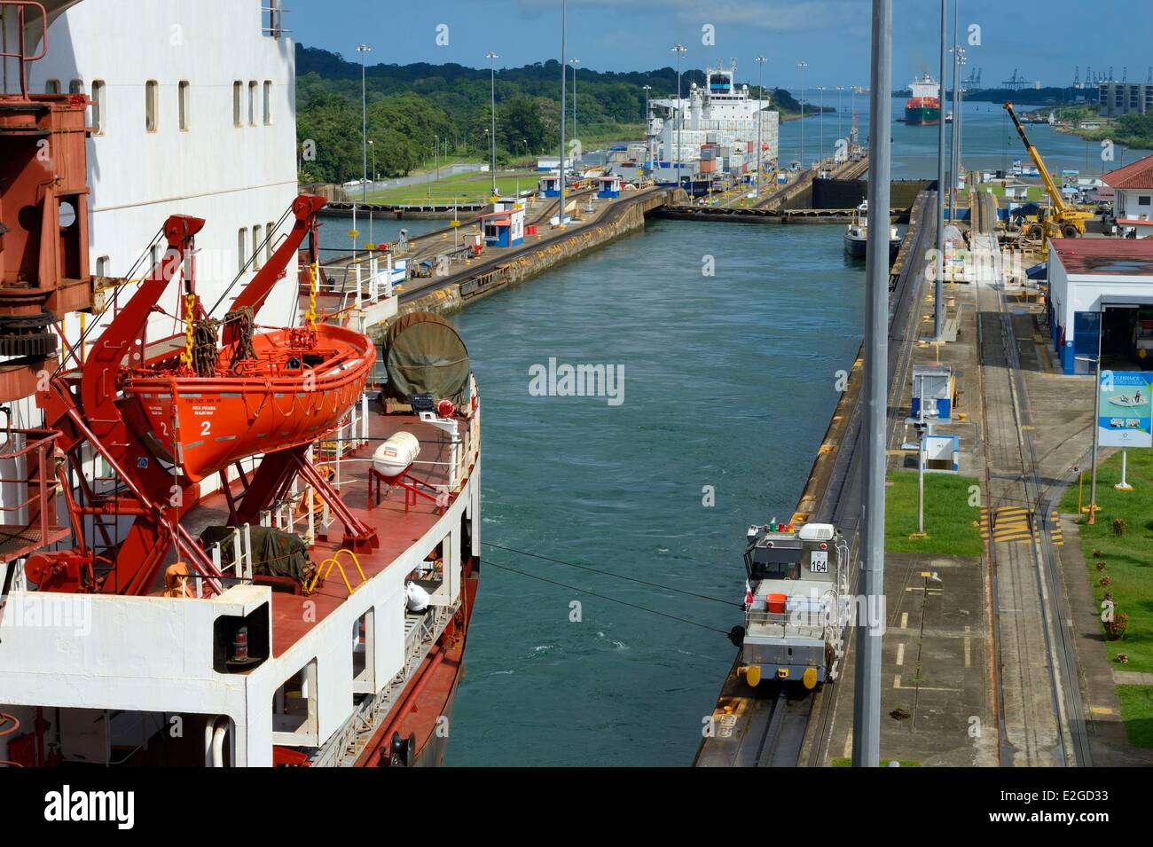 La province de Colon Panama Canal de Panama écluses de Gatun mules mécaniques ou électriques locomotives guider un navire porte-conteneurs Panamax entre murs de blocage Banque D'Images