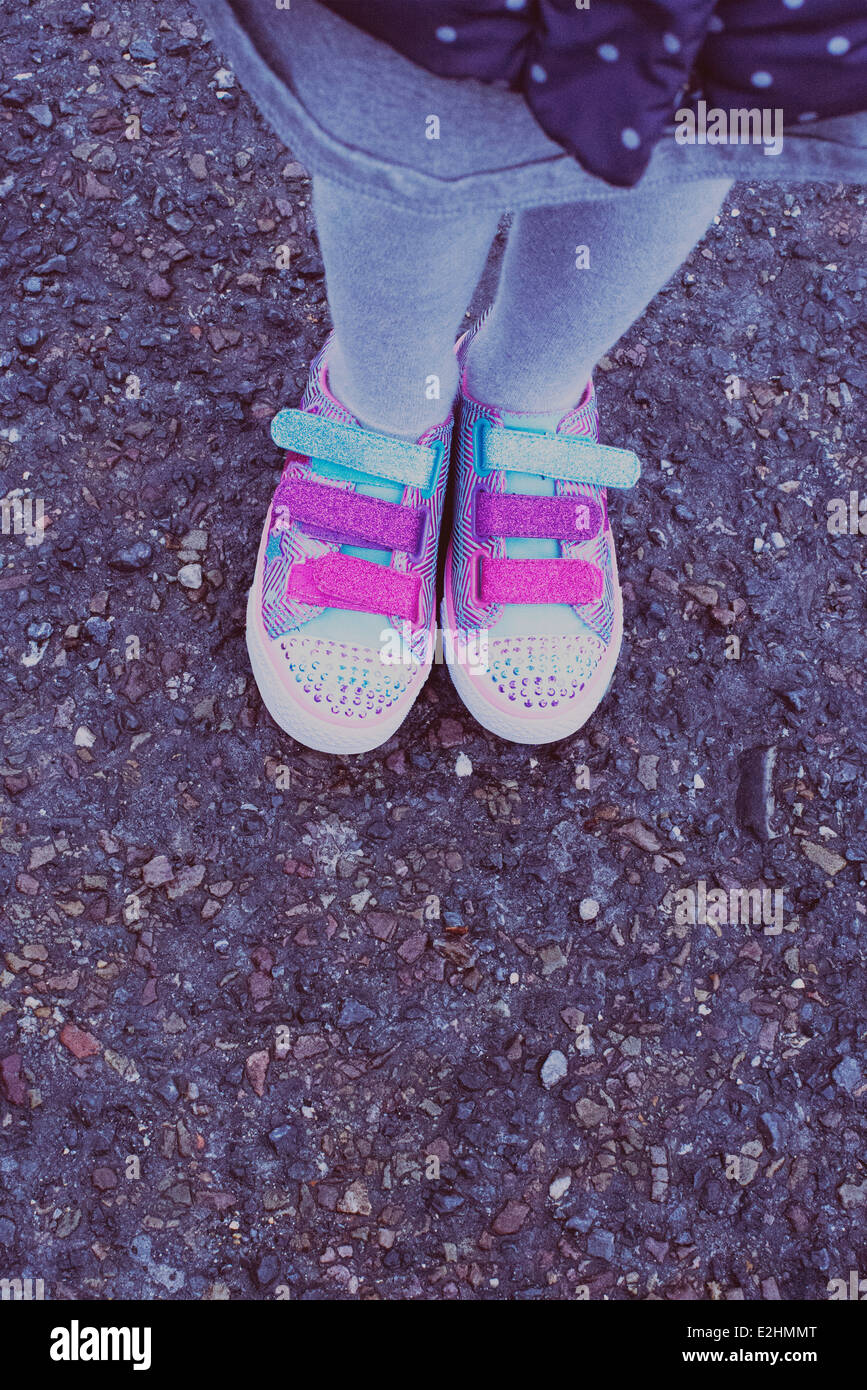 Girl wearing colorful sneakers, low section Banque D'Images