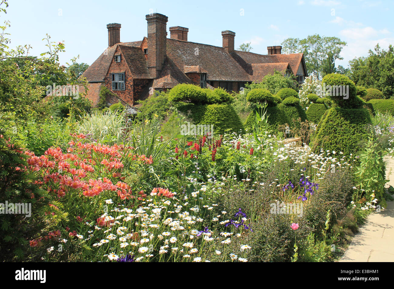 Le paon jardin topiaire et maison du xve siècle à Great Dixter, East Sussex, UK Banque D'Images