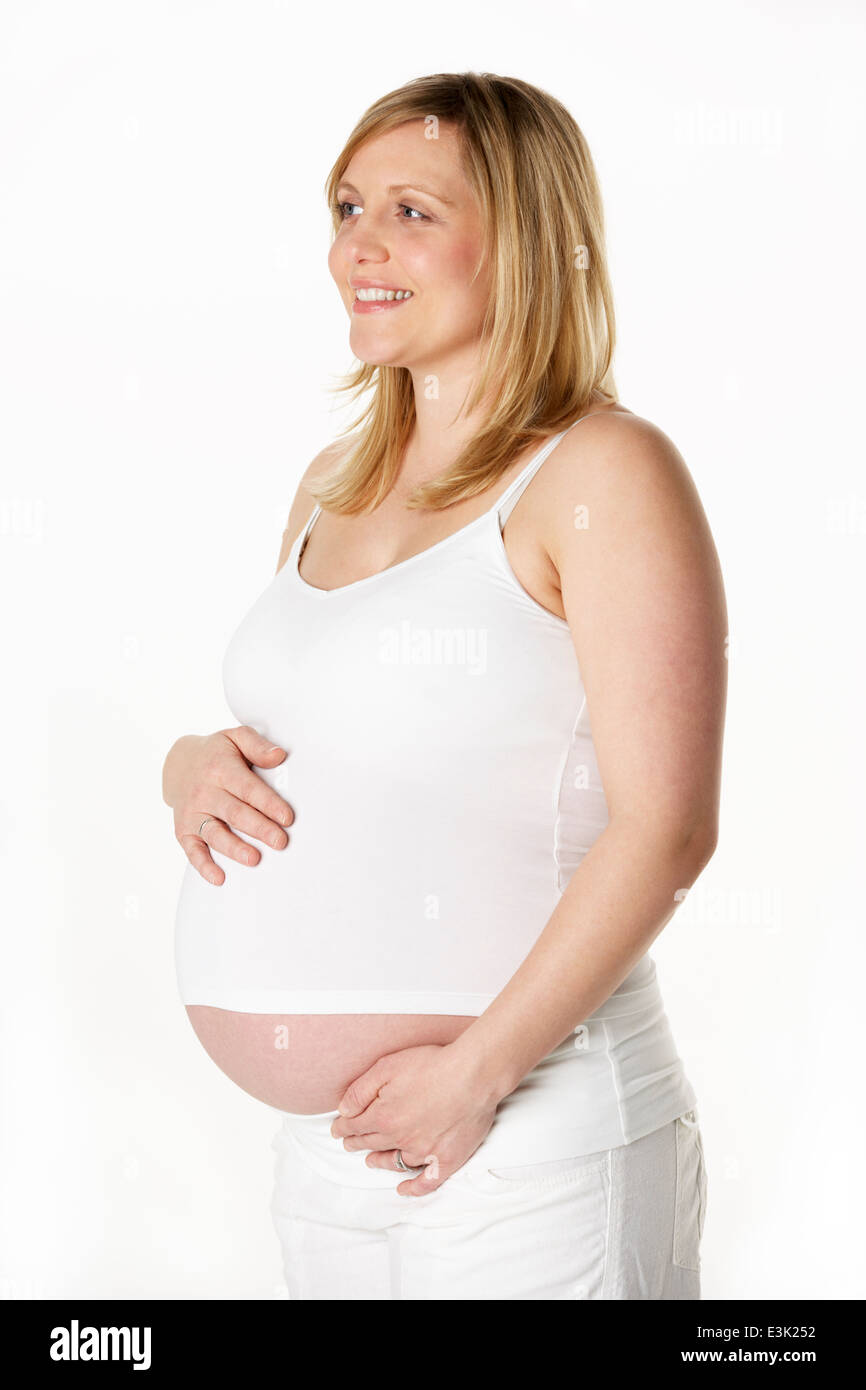 Studio Portrait of pregnant woman Wearing White Banque D'Images