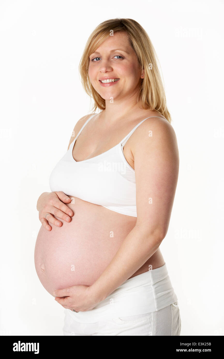 Studio Portrait of pregnant woman Wearing White Banque D'Images