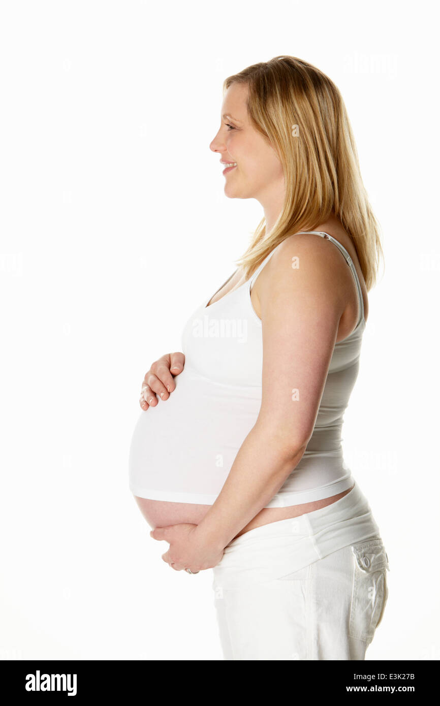 Studio Portrait of pregnant woman Wearing White Banque D'Images