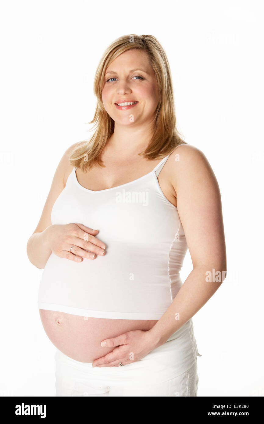Studio Portrait of pregnant woman Wearing White Banque D'Images