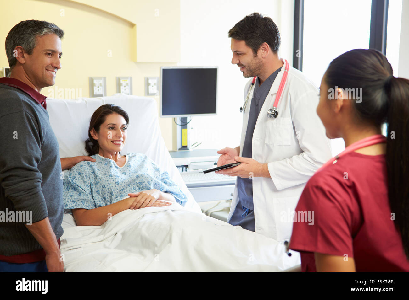 L'équipe médicale Rencontre avec couple In Hospital Room Banque D'Images