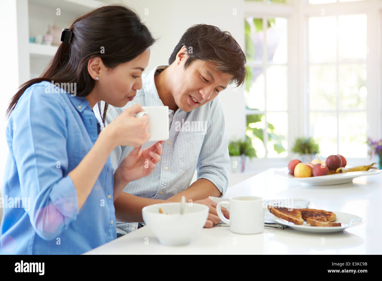Asian Couple Reading journal au petit déjeuner Banque D'Images