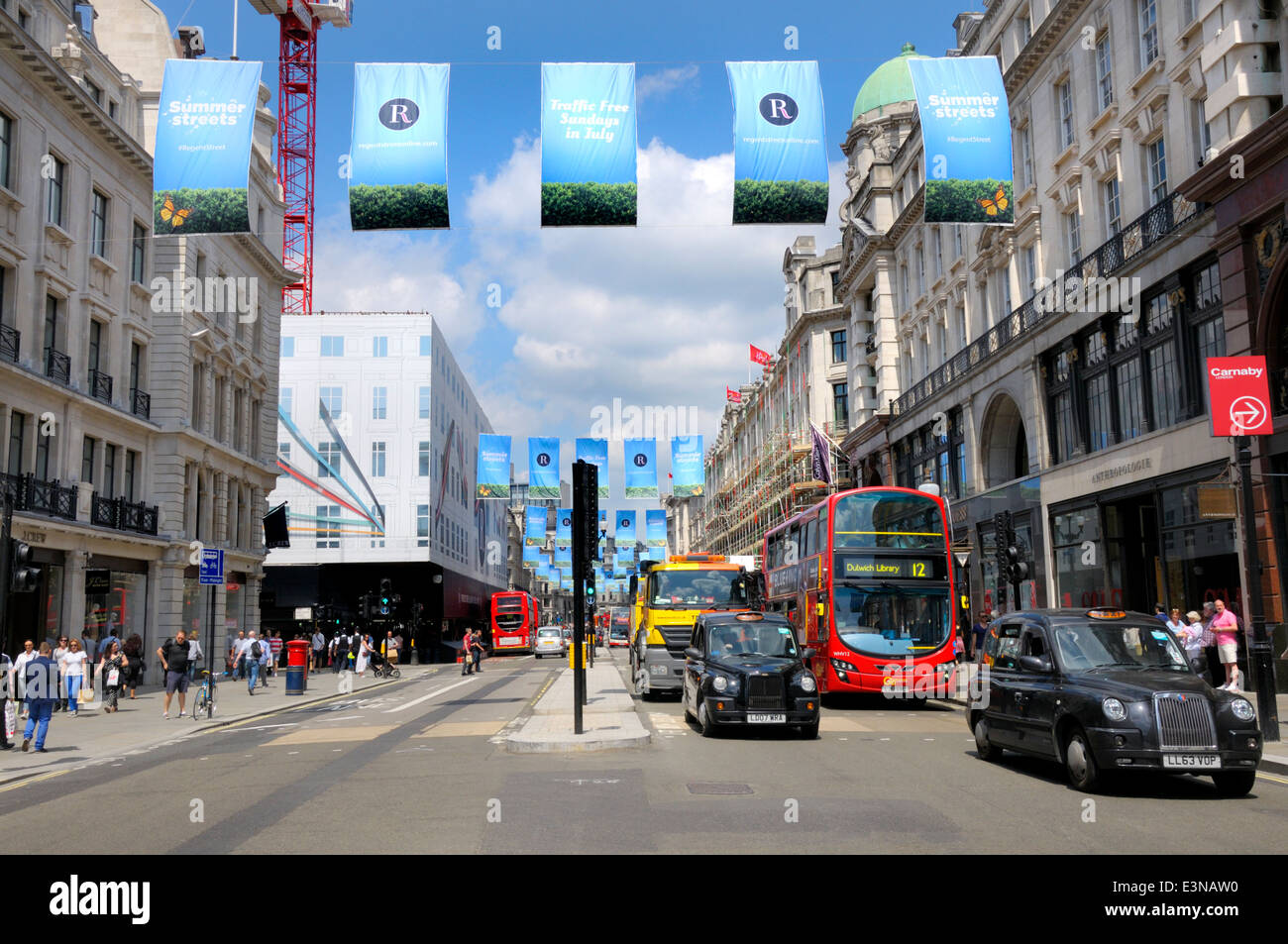 Londres, Angleterre, Royaume-Uni. Regent Street. Le trafic et les bannières bleues Faire connaître 'Trafic gratuitement les dimanches en juillet 2014" Banque D'Images