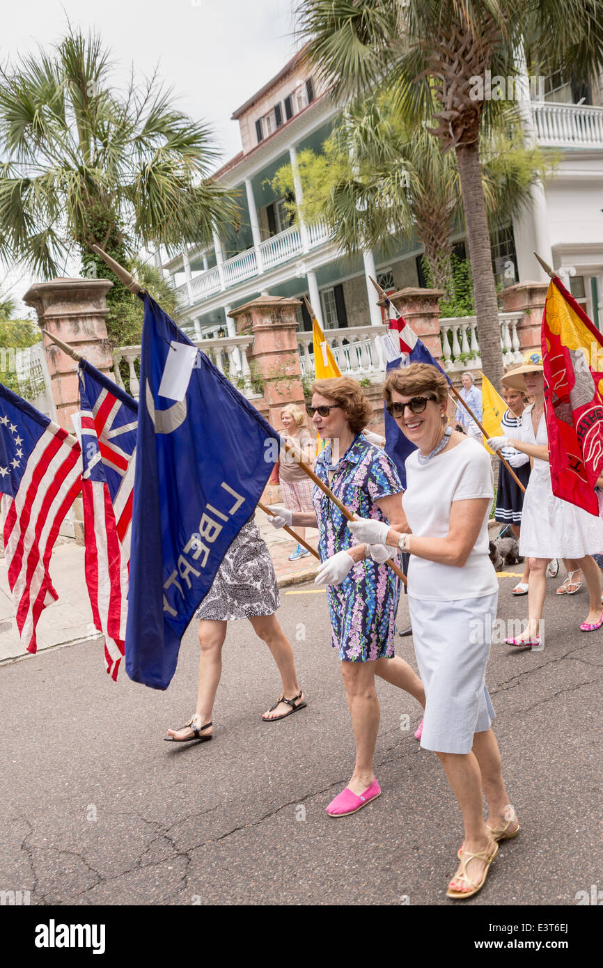 Les femmes portant des drapeaux de réunion de mars pour célébrer la Journée de la rue Caroline 28 juin 2014 à Charleston, SC. Carolina jour célèbre le 238e anniversaire de la victoire américaine à la bataille de Sullivan's Island au cours de la Royal Navy et l'armée britannique. Banque D'Images