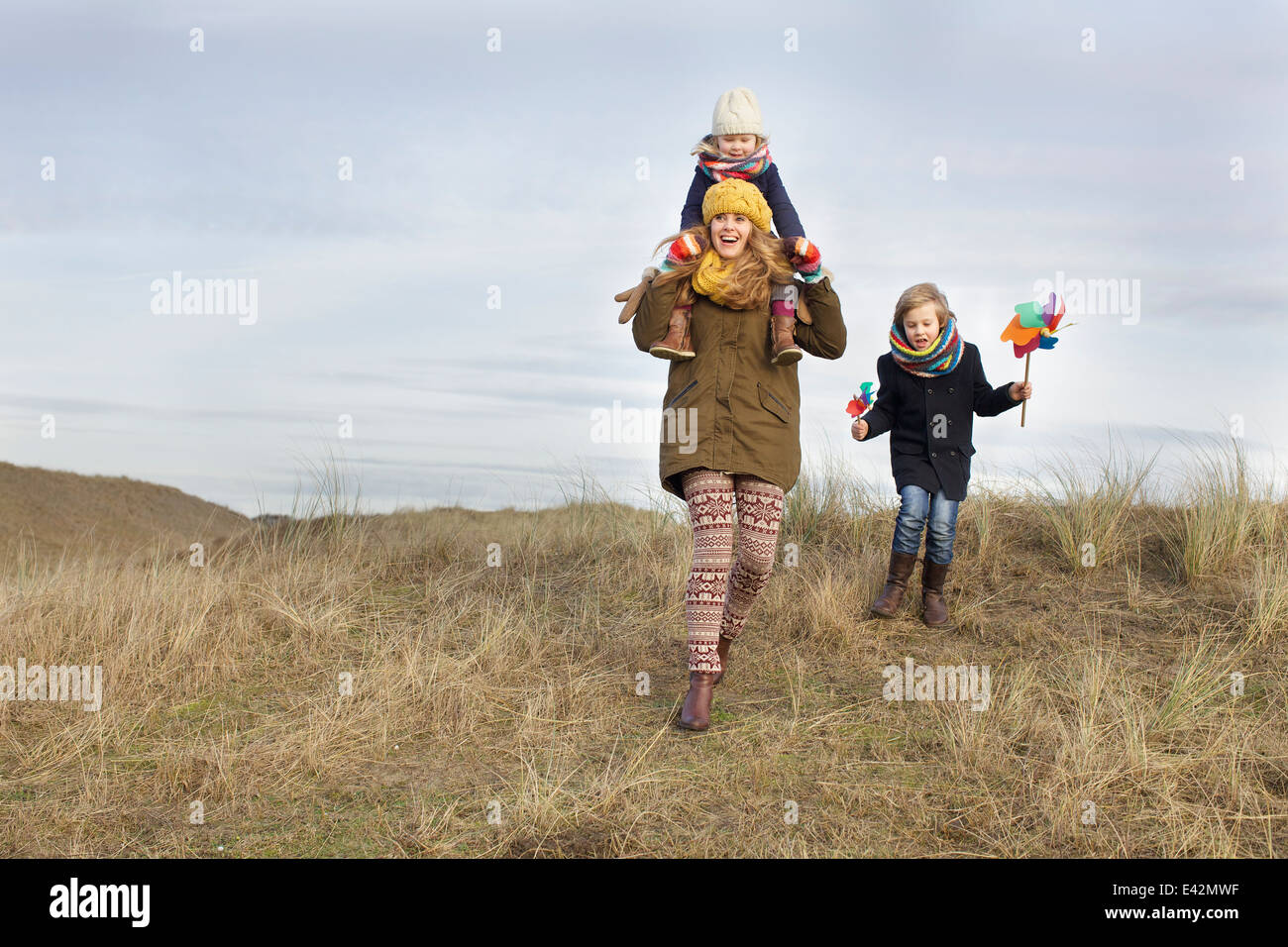 Smiling young woman with daughter and son at coast Banque D'Images