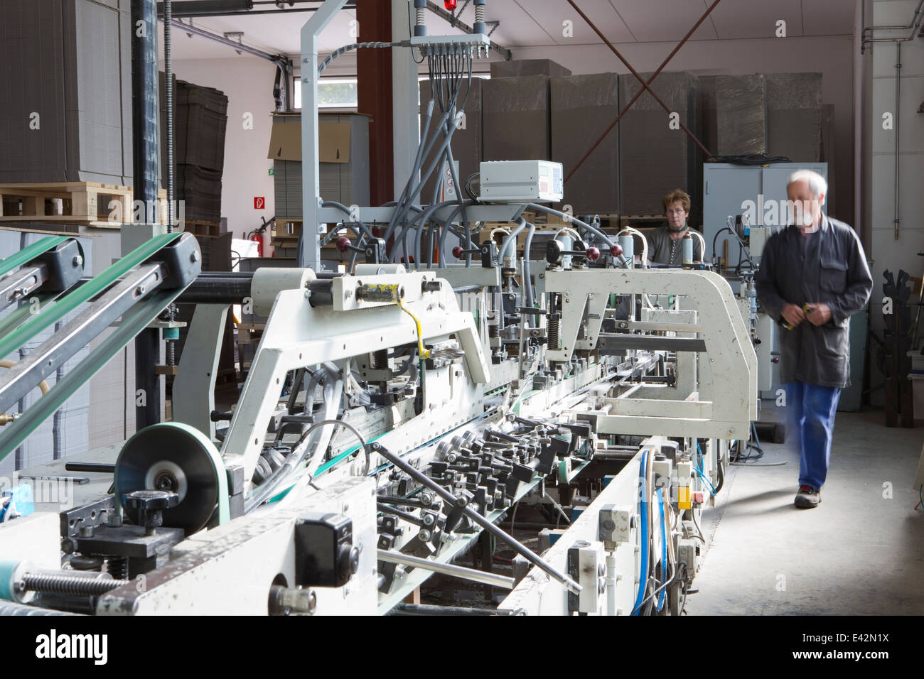 Les travailleurs d'usine de la machine en usine de carton Banque D'Images