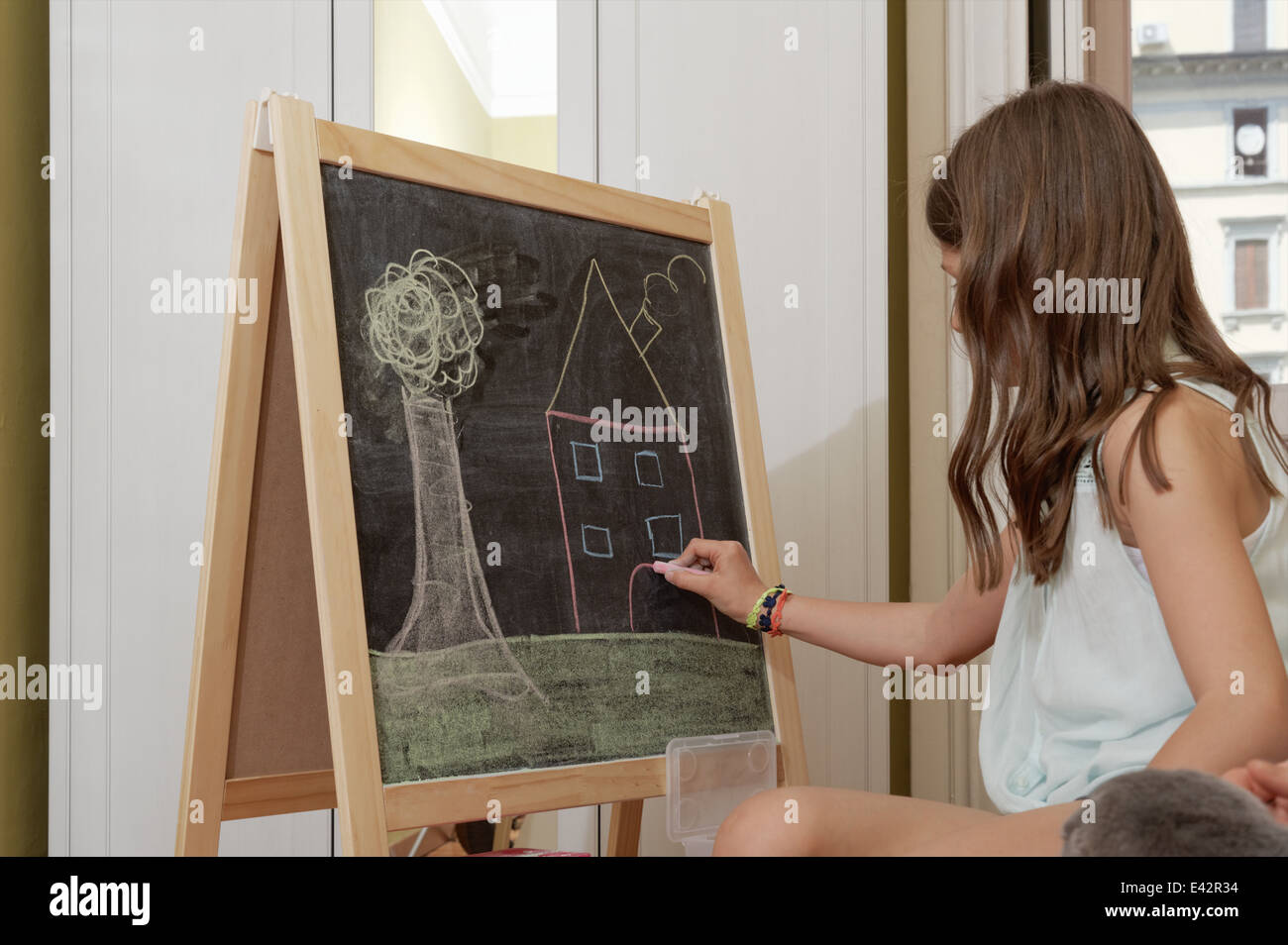 Girl drawing on blackboard Banque D'Images