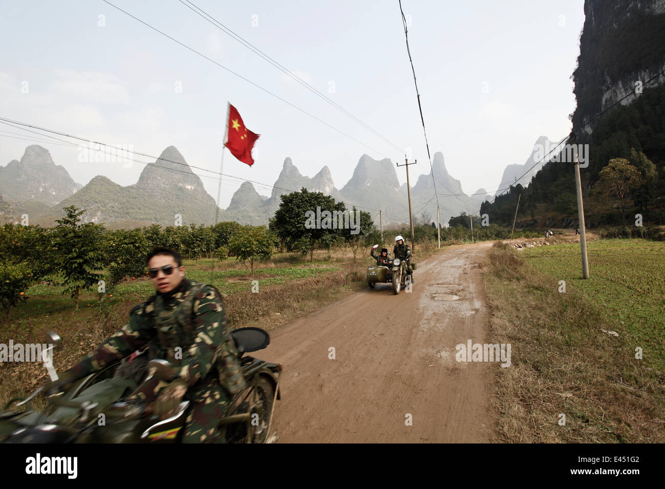 Motocycliste en face de montagnes karstiques de Yangshuo, Chine Banque D'Images