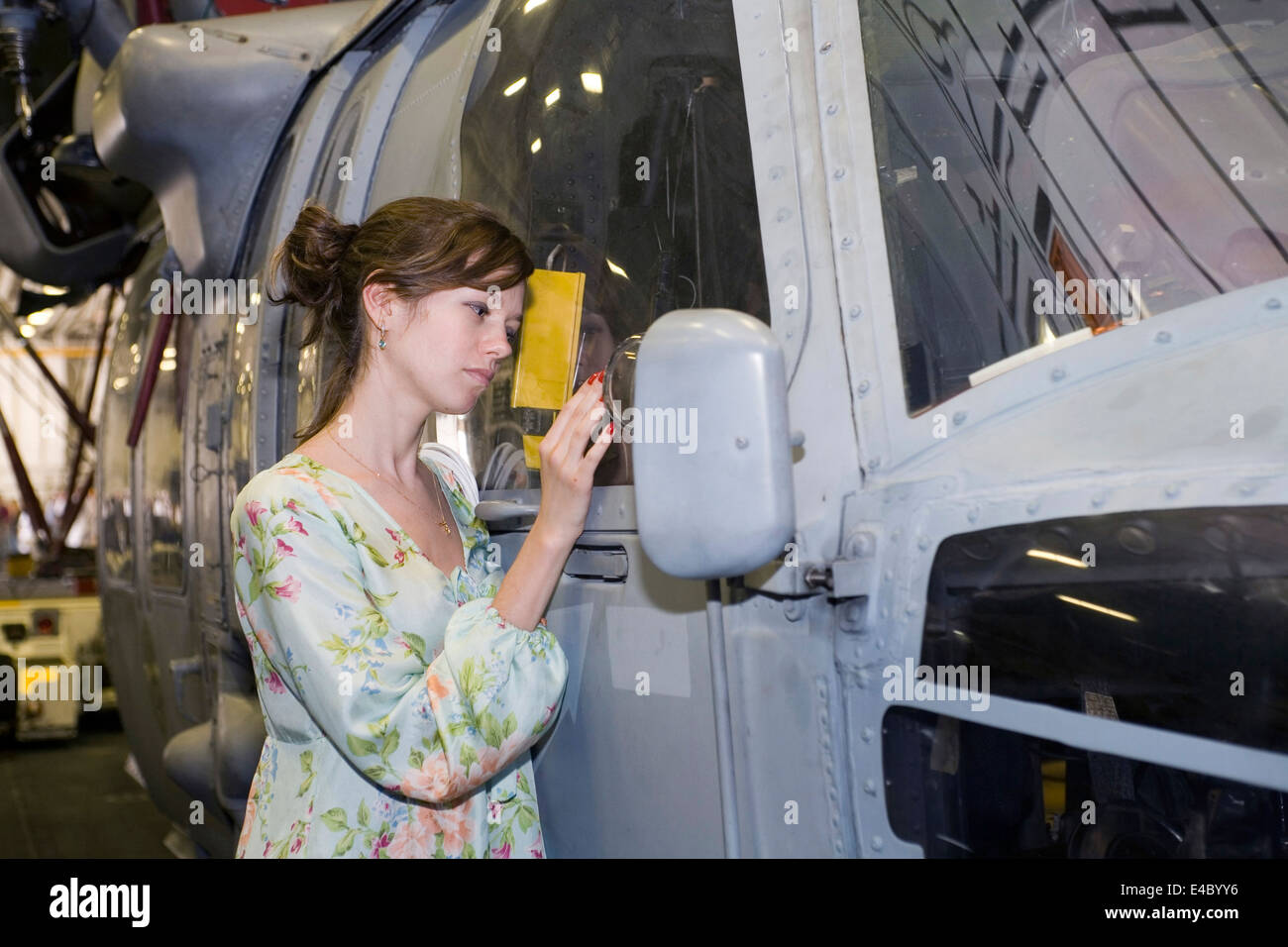 Jeune fille se tient à côté d'un hélicoptère Seahawk Sikorsky. Banque D'Images
