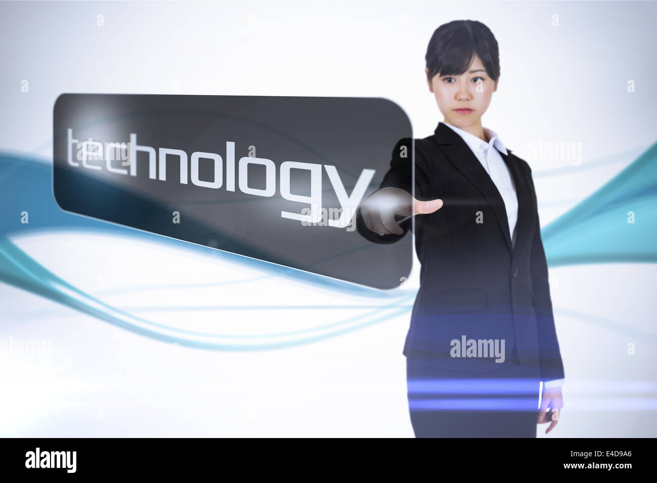 Businesswoman pointing to word technology Banque D'Images