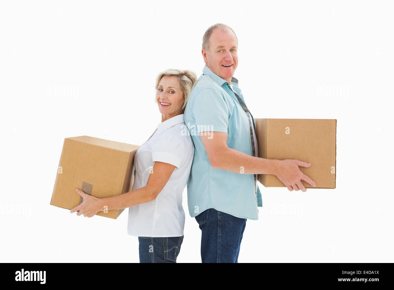 Happy older couple holding moving boxes Banque D'Images