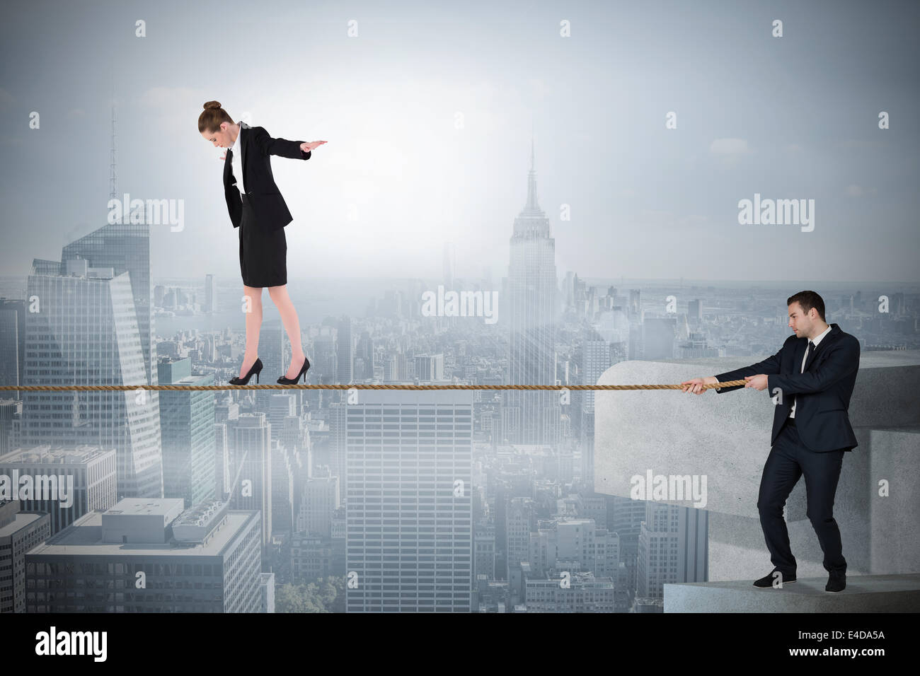 Jeune homme tirant une corde raide pour business woman Banque D'Images