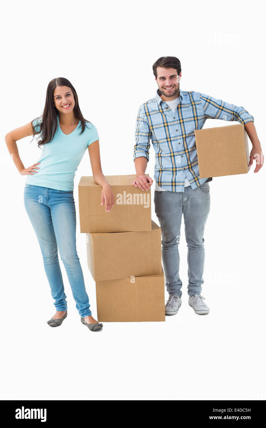 Attractive young couple with moving boxes Banque D'Images