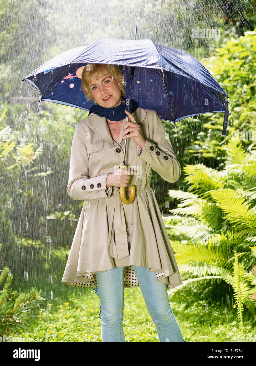 Femme mature et un parapluie, jour d'été pluvieux. Banque D'Images