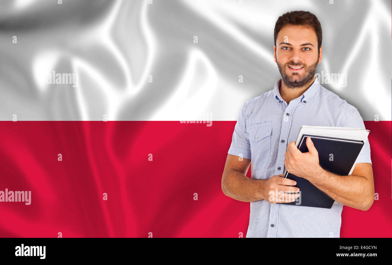 Young male student smiling over drapeau polonais. Banque D'Images