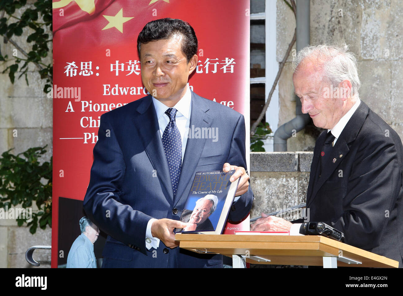 (140711) -- WILTSHIRE, 11 juillet 2014 (Xinhua) -- Robert Armstrong, le chef de Sir Edward Heath Charitable Foundation, présente un livre d'Edward Heath à l'autobiographie de Liu Xiaoming, ambassadeur de Chine en Grande-Bretagne, au cours d'une exposition photographique à la maison de l'ancien Premier ministre britannique Edward Heath, dans le Wiltshire, Angleterre, le 10 juillet 2014. Heath a servi comme premier ministre de la Grande-Bretagne à partir de juin 1970 à février 1974. Au cours de son mandat, la Grande-Bretagne a établi des relations diplomatiques avec la Chine en 1972. Il a rendu plusieurs visites en Chine pendant et après son mandat. (Xinhua/Xu Hui) Banque D'Images
