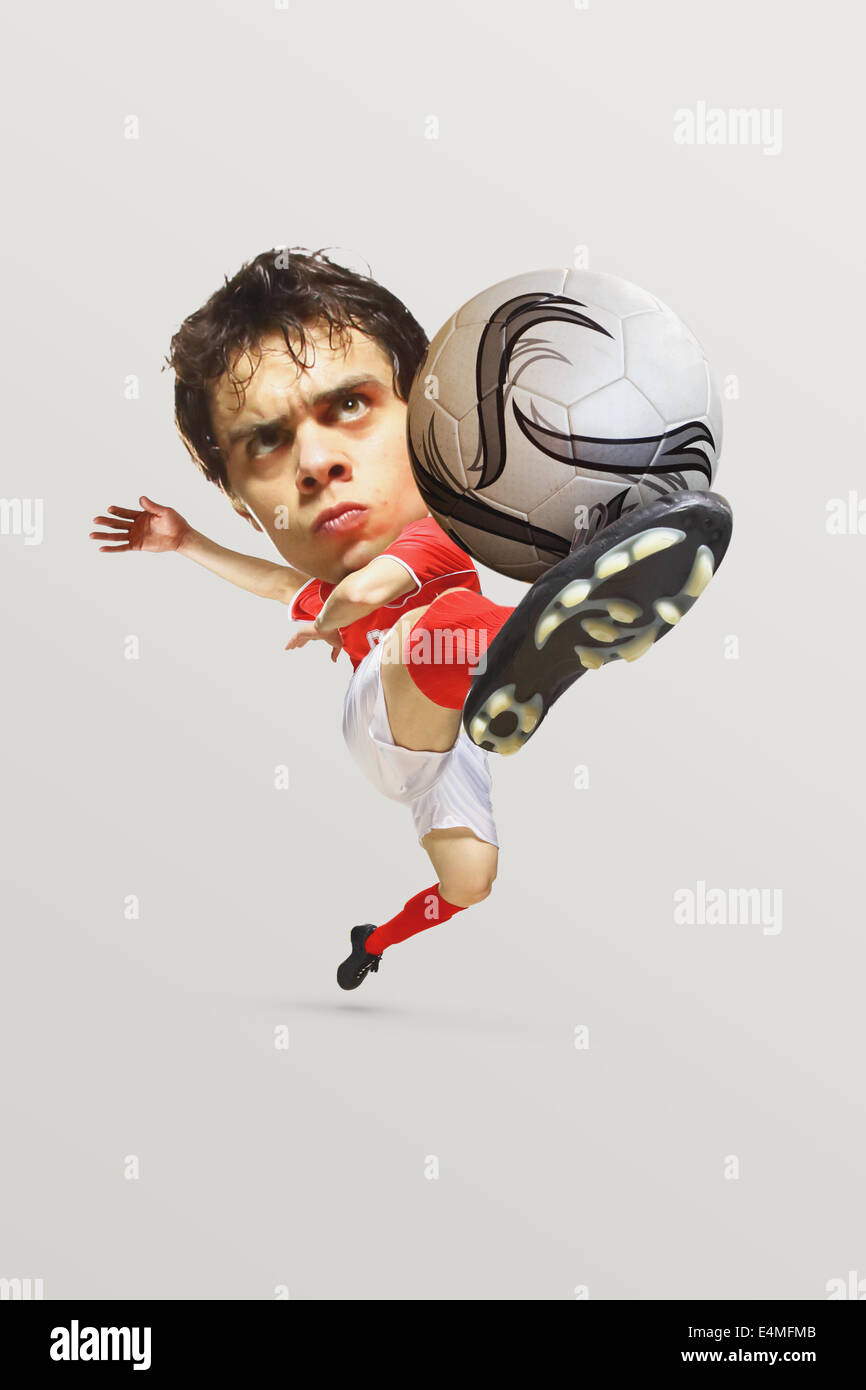 Soccer Player Kicking the ball in Mid-Air Banque D'Images