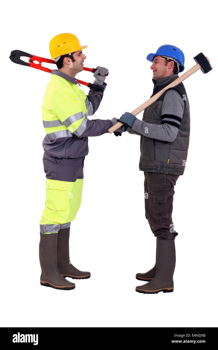 Male construction workers shaking hands Banque D'Images