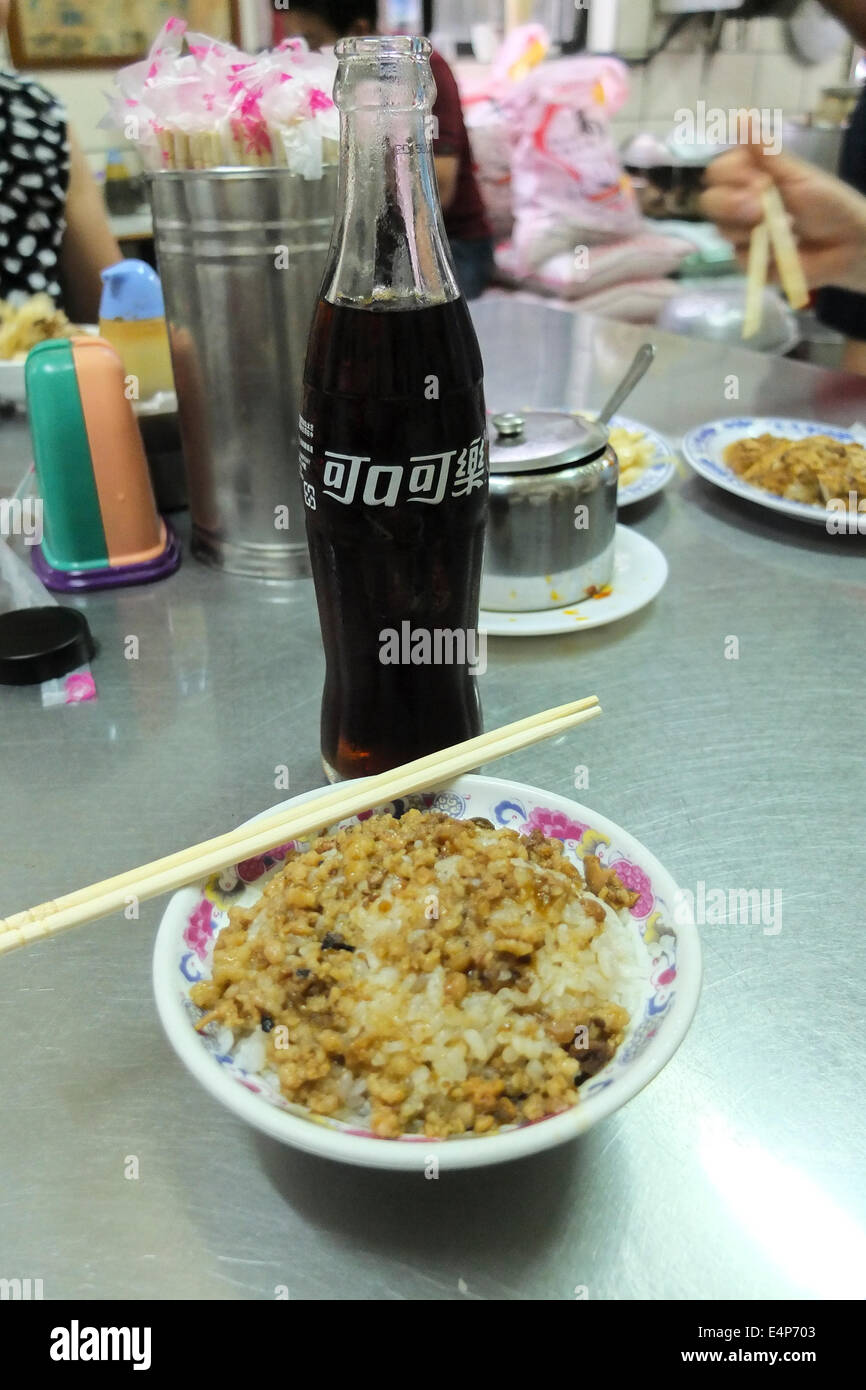 Coca Cola et un plat de riz sur une table en acier inoxydable dans un restaurant typique à Taiwan. Banque D'Images