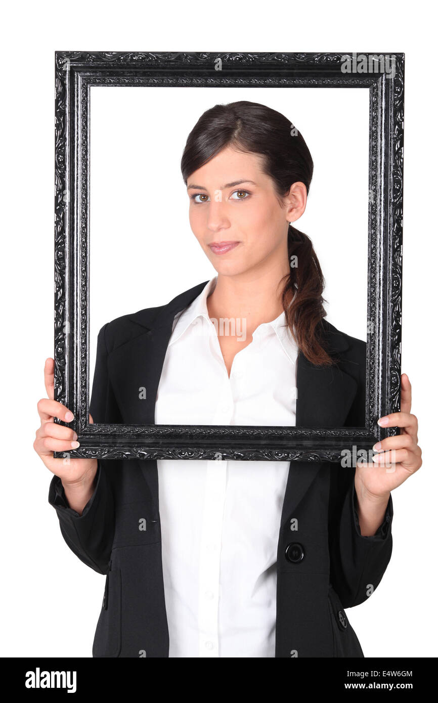 Woman holding empty picture frame Banque D'Images