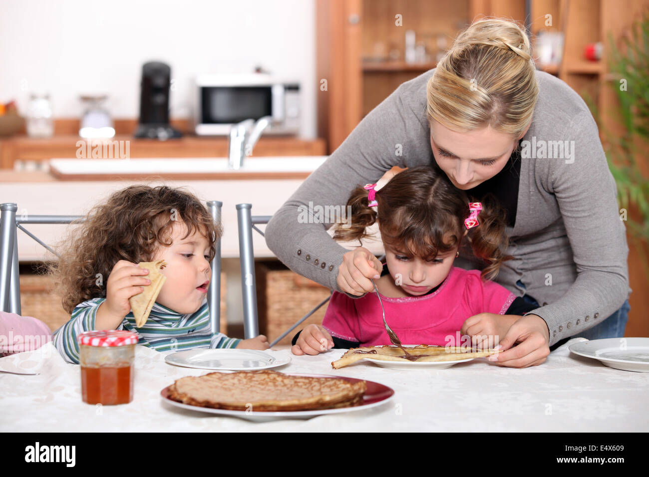 Les enfants de manger des crêpes pour le petit déjeuner Banque D'Images