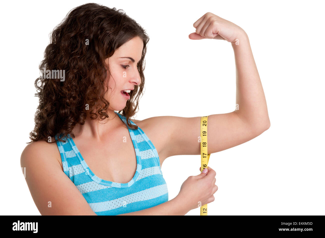 Surprised Woman measuring her biceps Banque D'Images