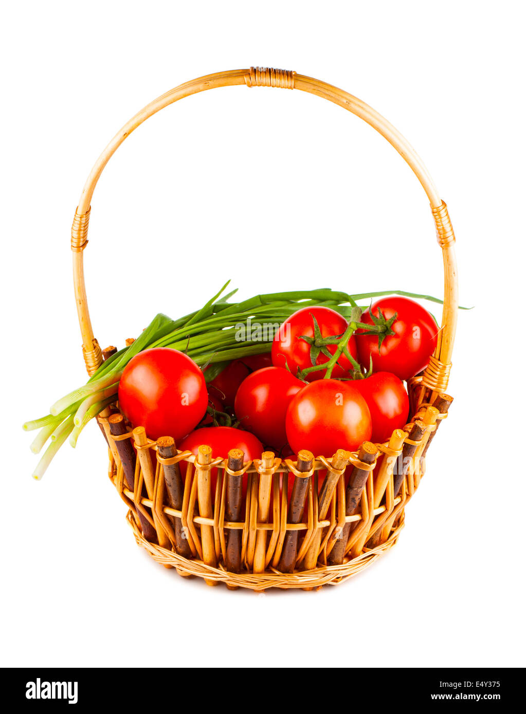 Panier en osier avec tomate et oignon vert Banque D'Images