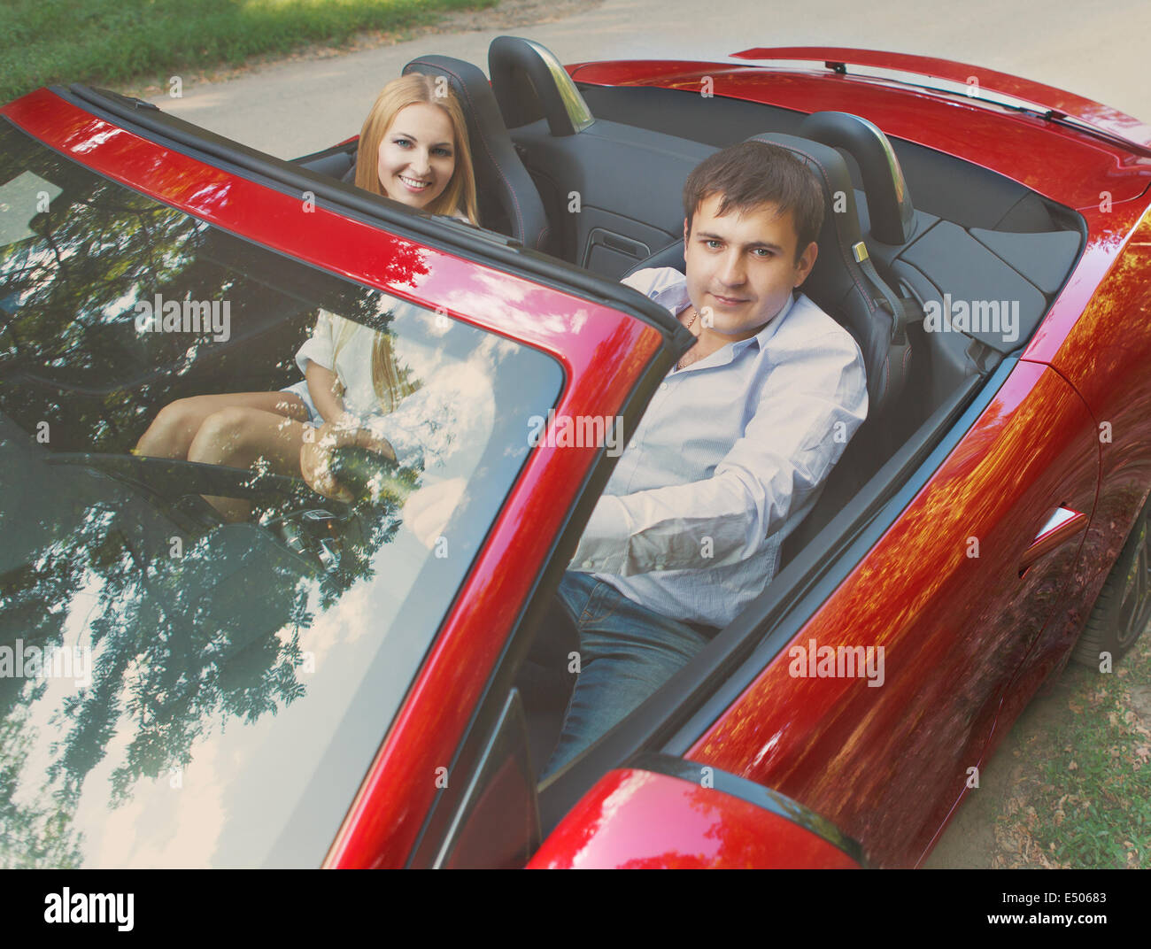 Heureux couple red cabriolet Banque D'Images