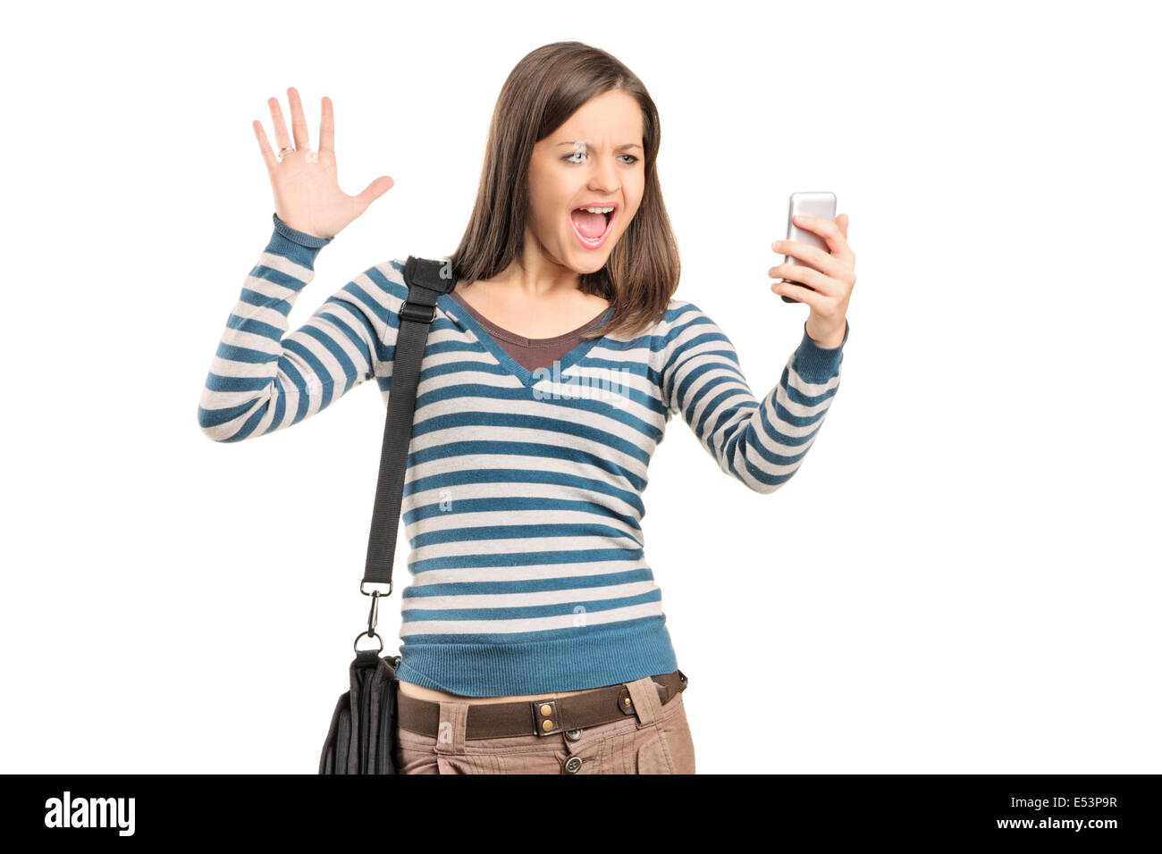 Angry girl looking at a cell phone Banque D'Images