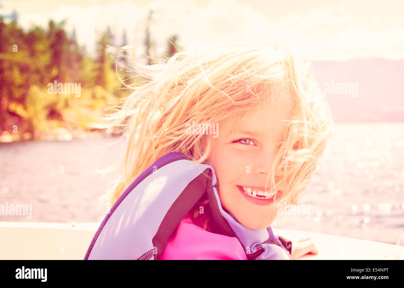 Smiling Little Girl dans un hors-bord dans le soleil de l'été Banque D'Images