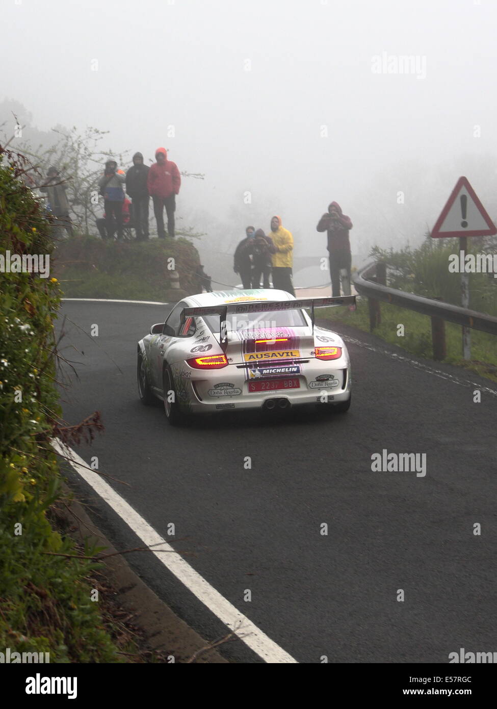 Hardy spectateurs regardant une Porsche 911 dans un matin tôt spéciale dans les montagnes de Gran Canaria, au cours de l'El Corte Ingles, rallye 2014. Banque D'Images