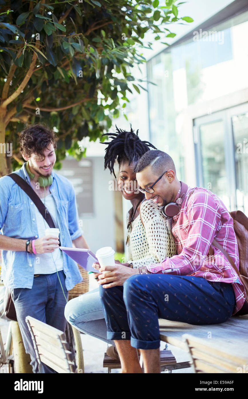 Friends talking at sidewalk cafe Banque D'Images