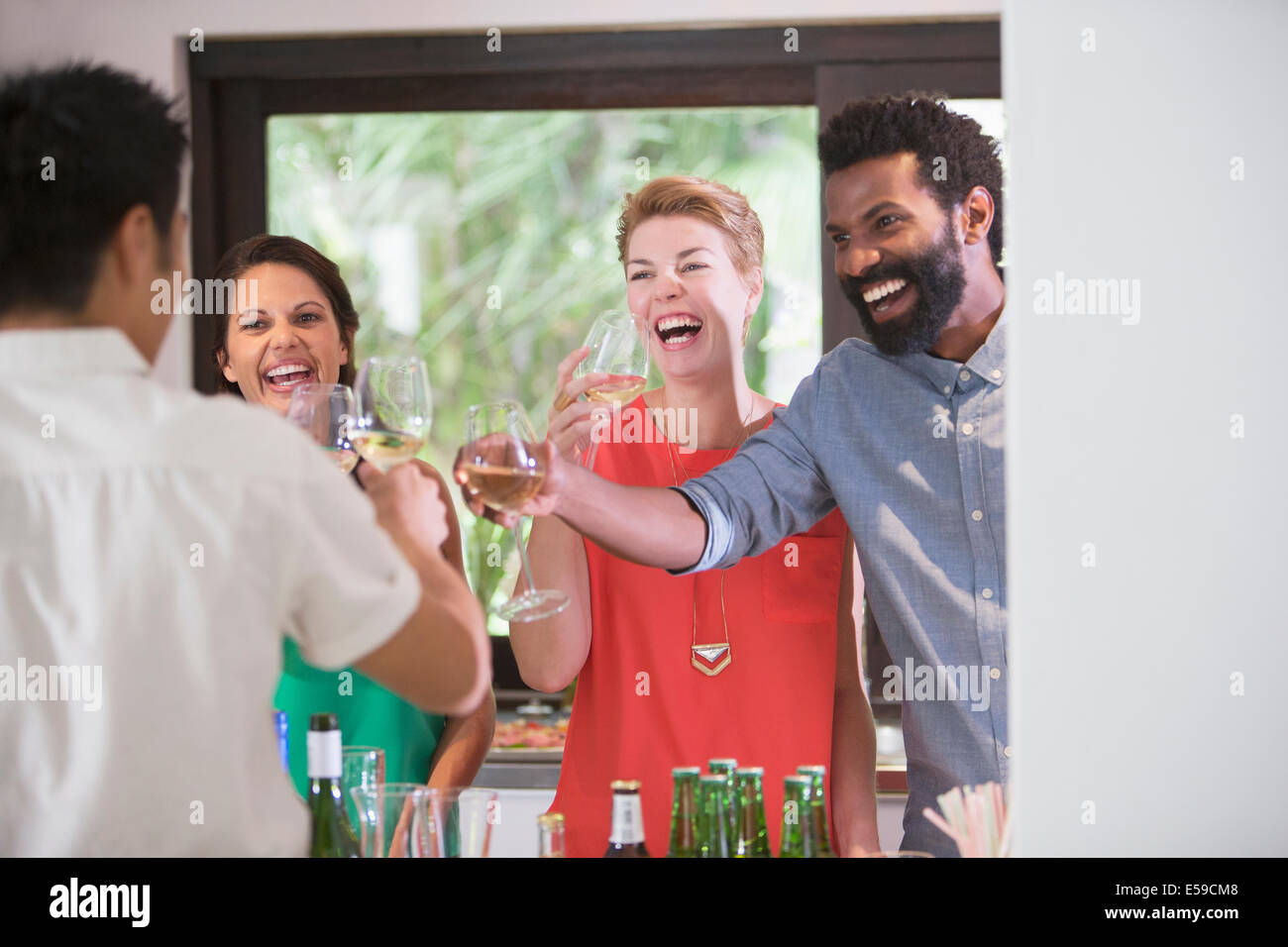 Friends toasting each other at party Banque D'Images