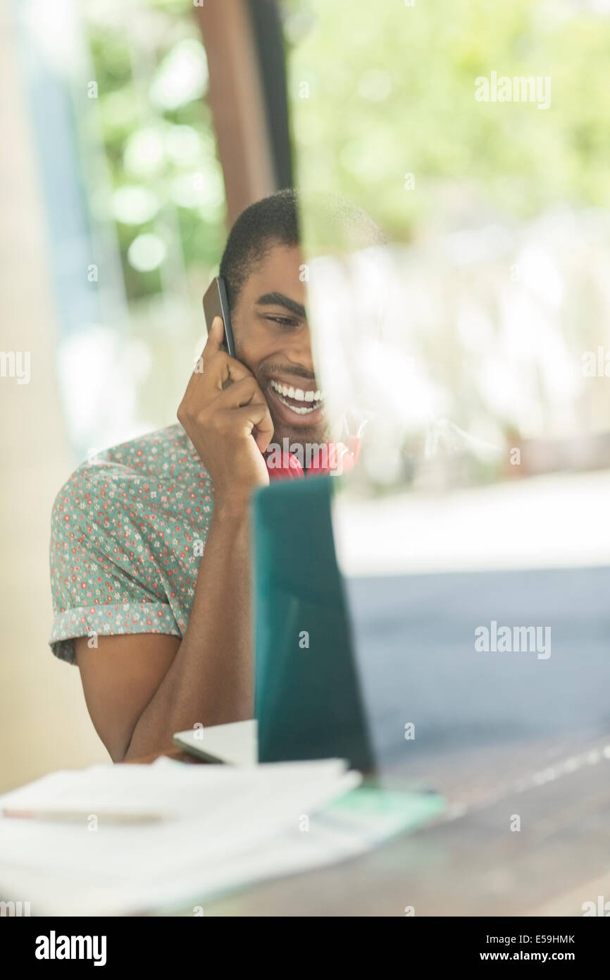 Man talking on cell phone in office Banque D'Images