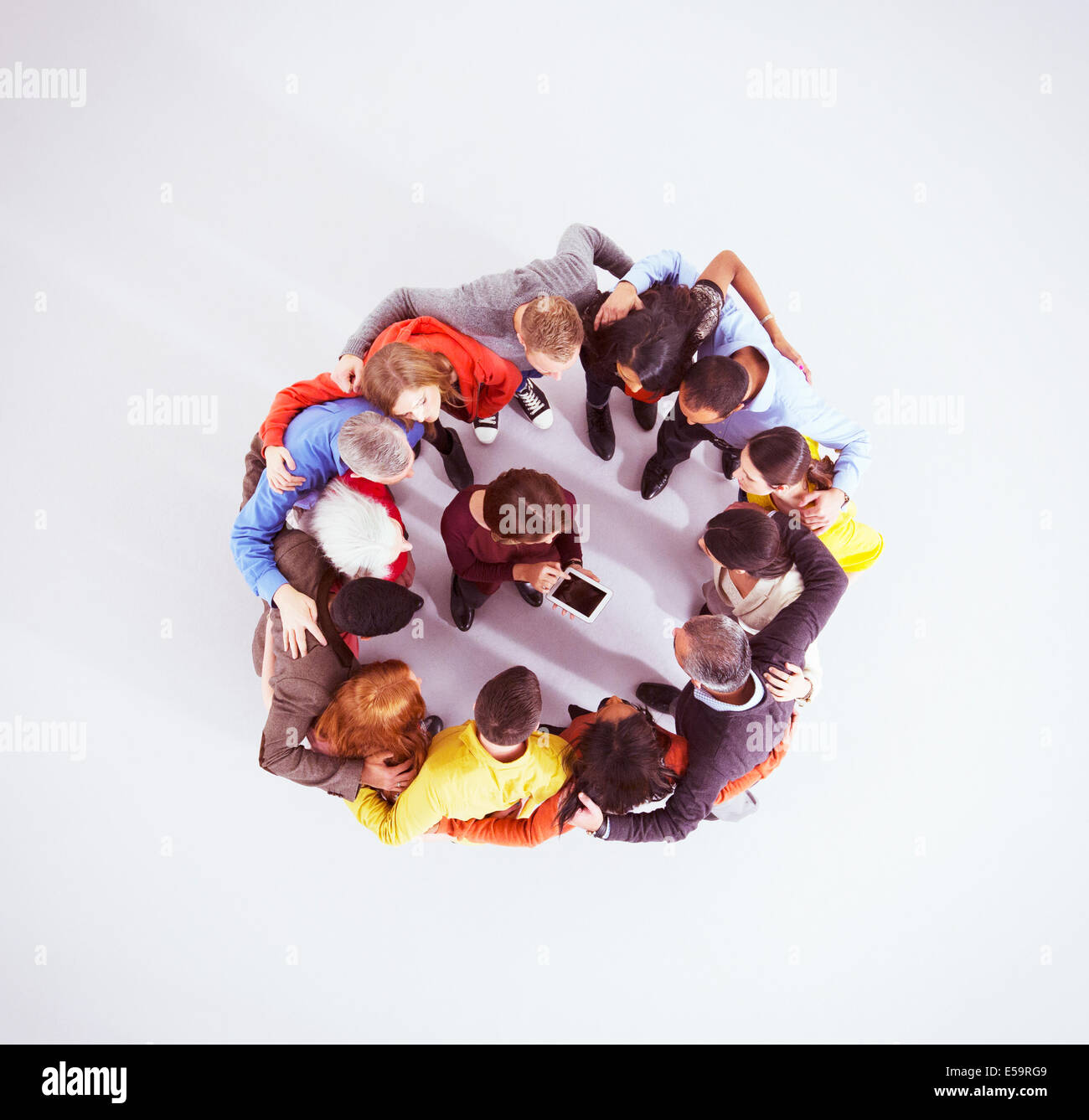 Les gens d'affaires regroupés autour de woman with digital tablet Banque D'Images