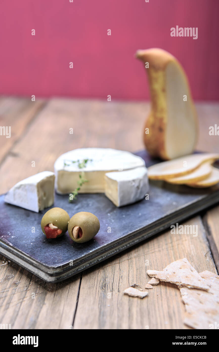 Nature morte avec assiette de fromage et les olives sur la table Banque D'Images