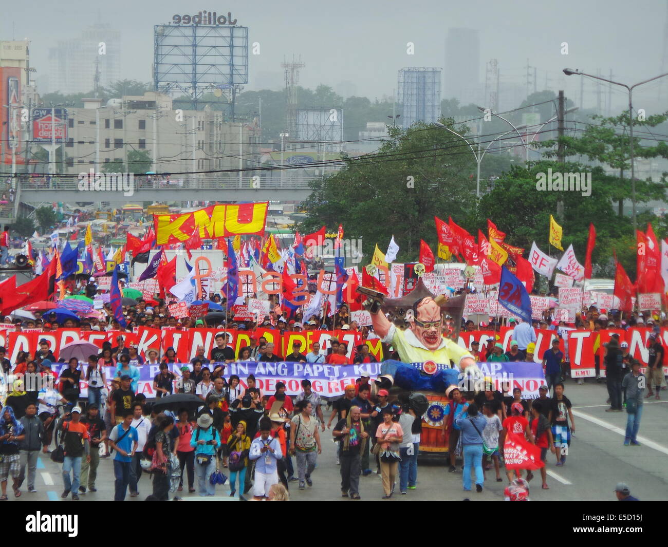 Quezon City, Philippines. 28 juillet, 2014. Sur la cinquième année du président Benigno "Noynoy" Aquino sur l'état de la Nation (SONA), des milliers de mécontents des groupes militants sur sa performance en tant que président ont marché vers Batasang Pambansa (Chambre du Congrès) dans la ville de Quezon avec leurs pancartes - tenue d'Aquino responsables de pillage des P144 milliards de dollars du Programme d'accélération des versements (DAP) - fonds et effigie de Aquino comme 'king' de l'assiette au beurre. 10 000 policiers ont été éliminés de la ville afin d'assurer l'ordre. Sherbien Dacalanio : Crédit / Alamy Live News Banque D'Images