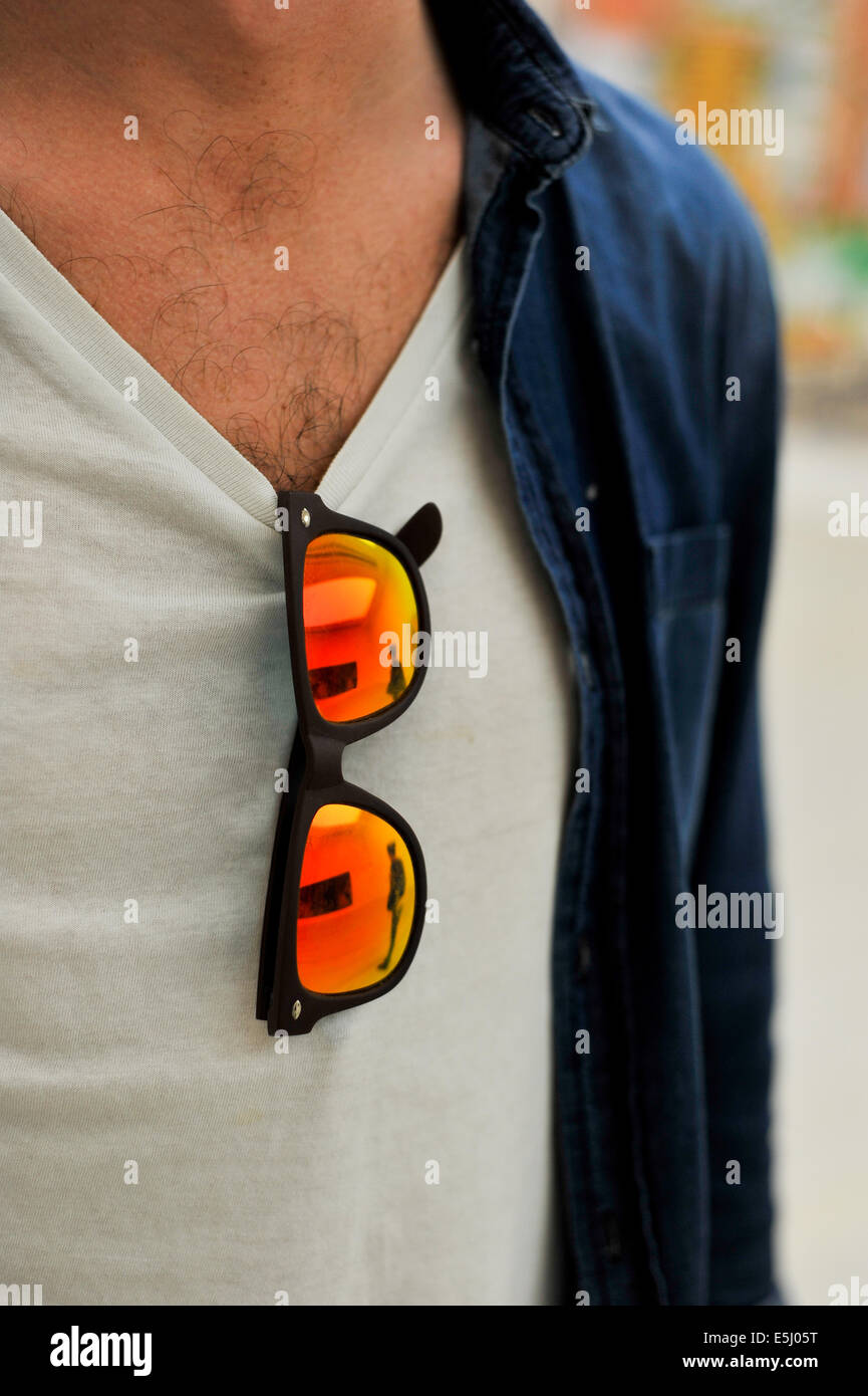 Lunettes qui pendaient du t-shirt d'un homme Banque D'Images