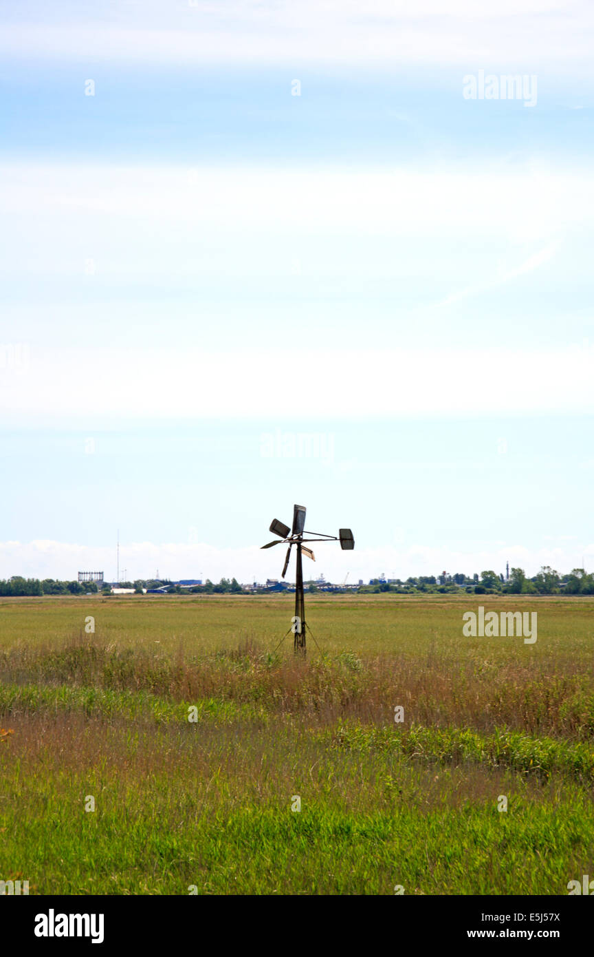 Une petite pompe éolienne par une digue sur les pâturages de marais près de Great Yarmouth, Norfolk, Angleterre, Royaume-Uni. Banque D'Images