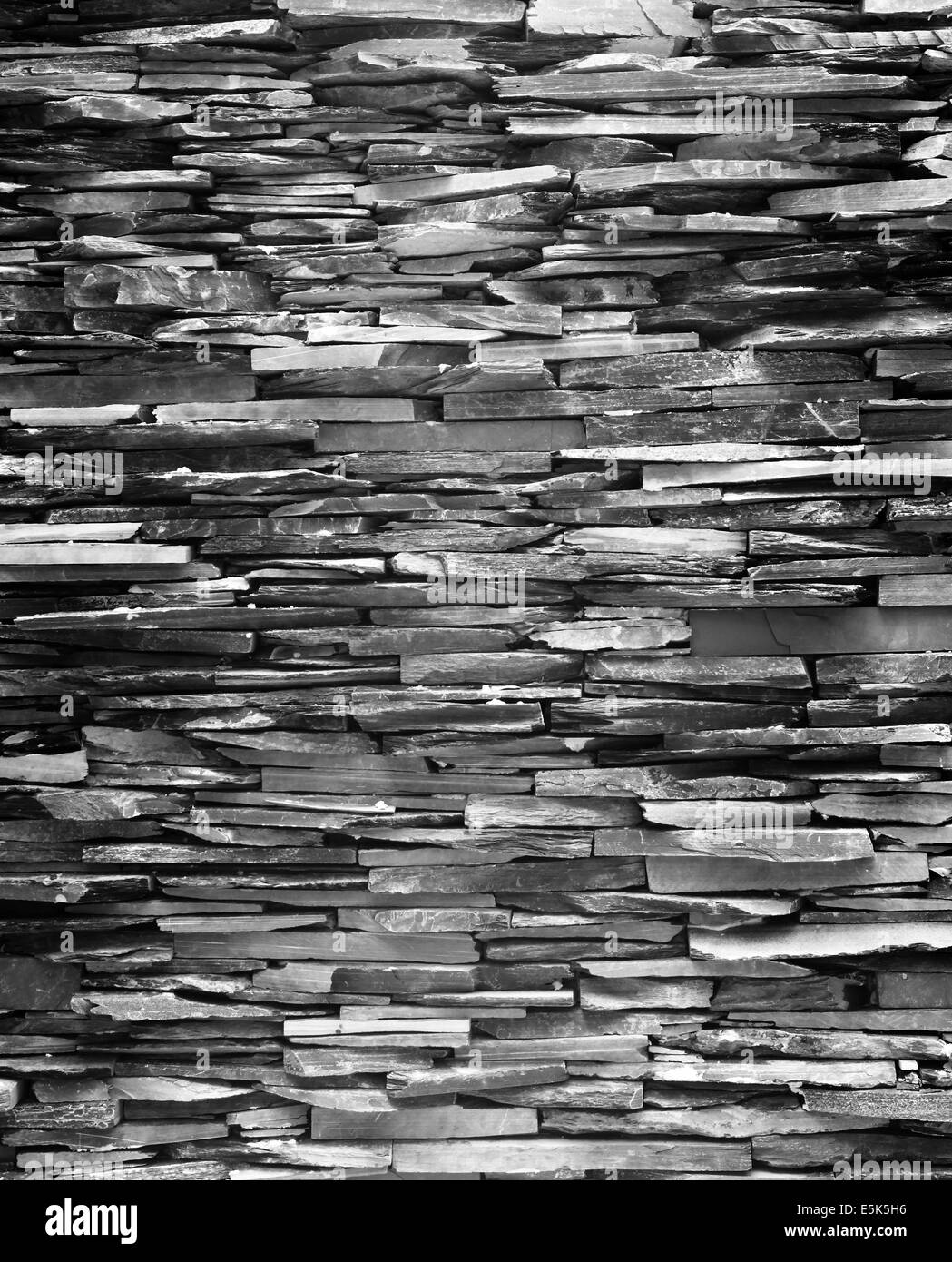 Mur en pierre de construction de mur noir fond plus fort. Banque D'Images Mur en pierre de construction de mur noir fond plus fort. Banque D'Images