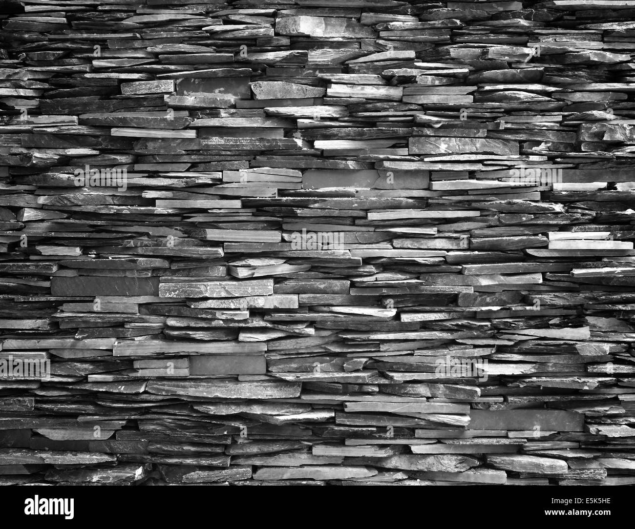 Mur en pierre de construction de mur noir fond plus fort. Banque D'Images Mur en pierre de construction de mur noir fond plus fort. Banque D'Images
