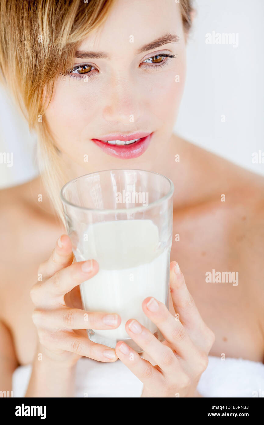 Femme buvant un verre de lait. Banque D'Images