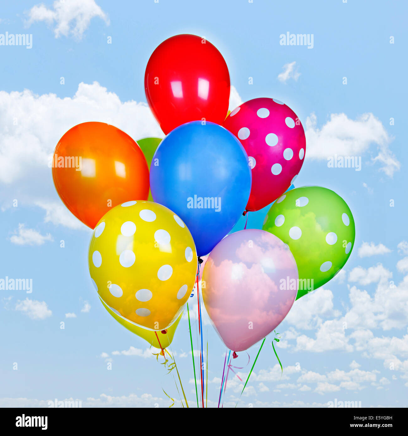 Colorful ballons à l'hélium sur ciel bleu avec des nuages Banque D'Images